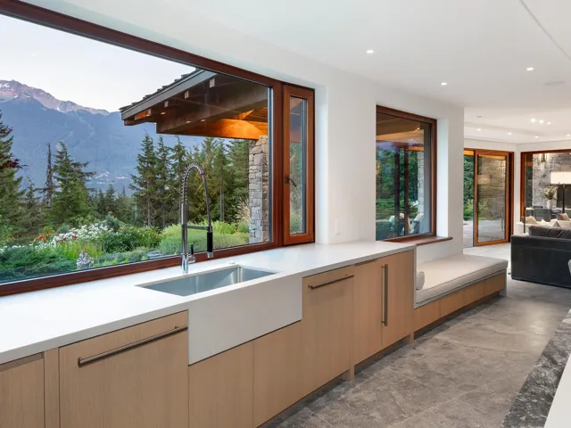 Bar featuring a mountain view, modern cabinets, light brown cabinetry, recessed lighting, and light stone countertops
