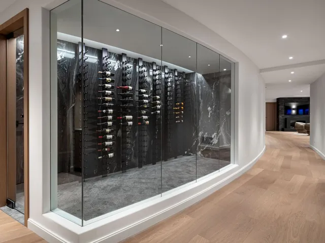 Wine room featuring wood finished floors, elevator, and recessed lighting