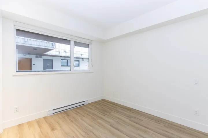 Detailed view of mountains, wood finished floors, and a baseboard heating unit