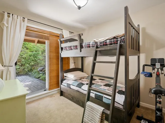 Room featuring bunk beds, neutral carpeting, and a glass sliding door