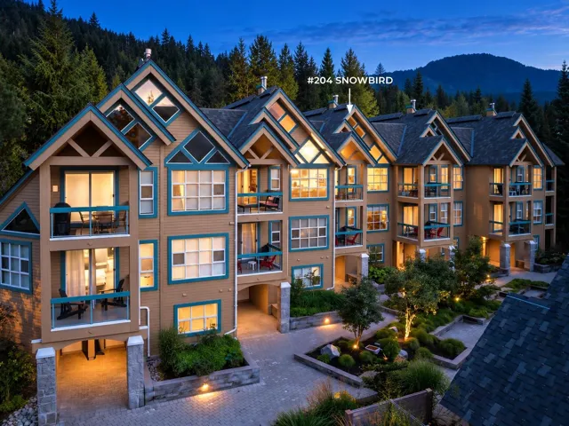 Multi-level building with individual balconies, gabled rooflines, and dormer windows
