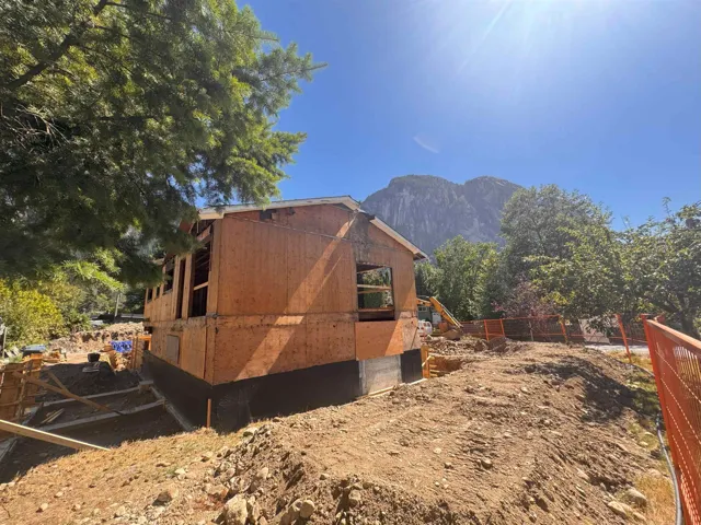 View of home's exterior with a mountain view and an outdoor structure