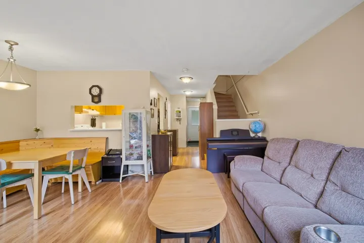 Living room with light wood-style floors and stairs