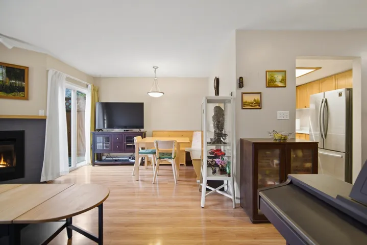 Living room featuring light wood finished floors and a glass covered fireplace