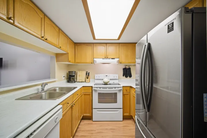 Living area featuring a baseboard heating unit and light wood-style flooring
