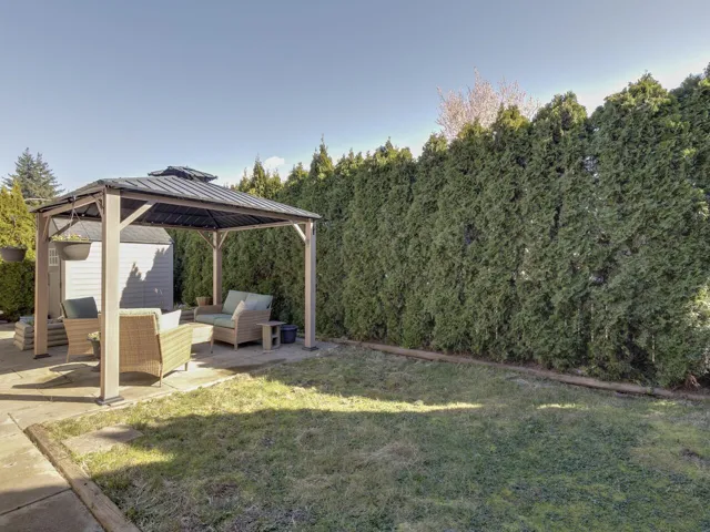 View of green lawn featuring a gazebo, outdoor seating, and a patio