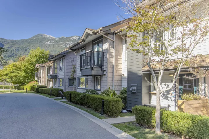 Townhome exterior featuring horizontal siding and shaker shingles