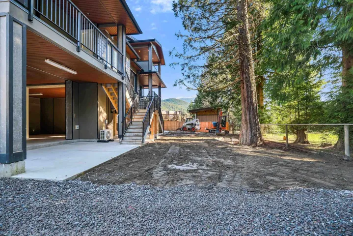 Fenced yard with a patio area and stairs