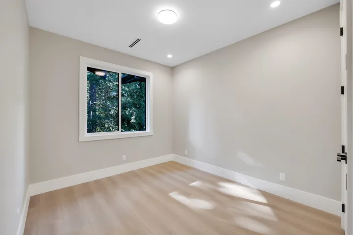 Spare room with light wood finished floors and recessed lighting