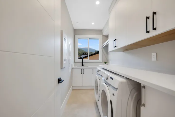 Laundry room with cabinet space, recessed lighting, and washer and dryer