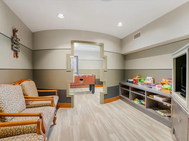 Recreation room featuring light carpet and recessed lighting