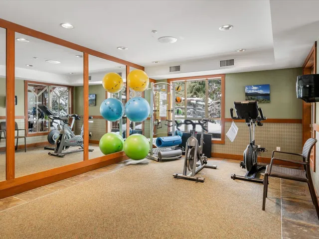 Gym featuring recessed lighting and a wainscoted wall