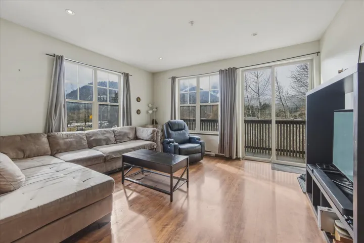 Living room with wood finished floors and recessed lighting