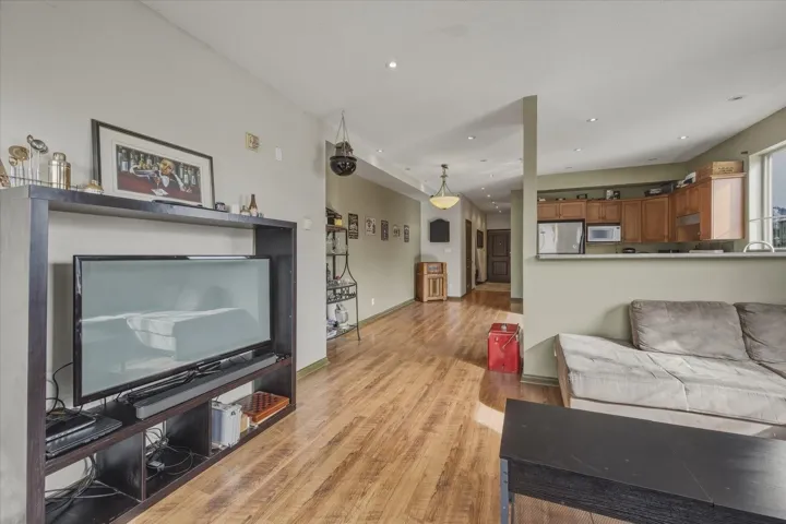 Living room with light wood finished floors and recessed lighting