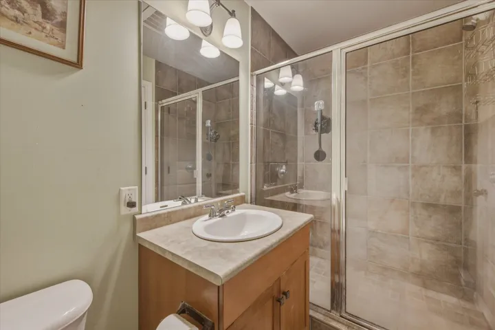 Full bathroom featuring vanity and a shower stall