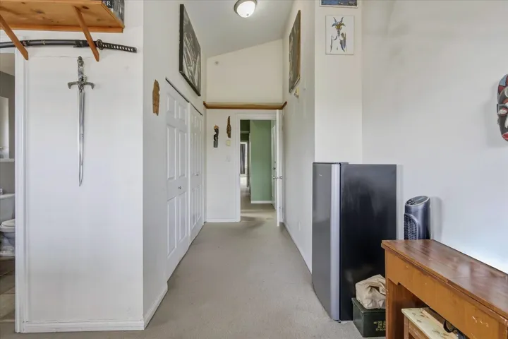 Hall with light carpet and baseboards