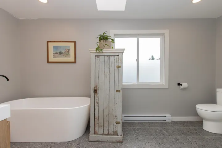 Full bath featuring a freestanding tub and recessed lighting