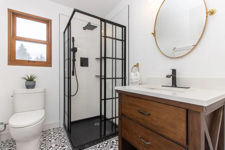 Bathroom featuring vanity, a shower stall, and tile patterned floors