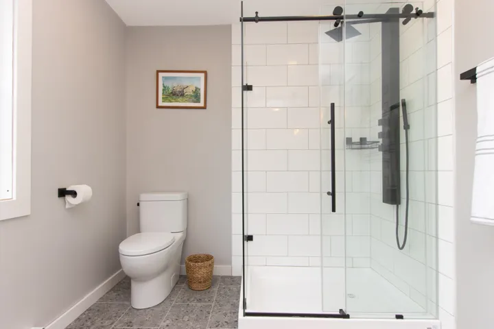 Bathroom with a large shower and tile flooring