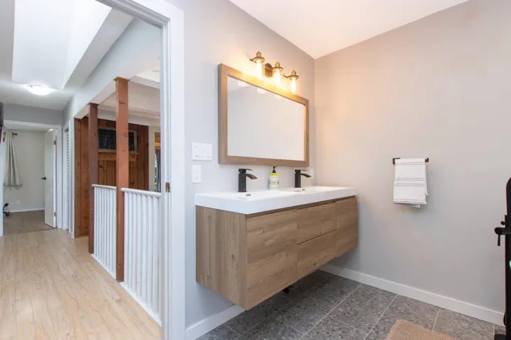Bathroom with baseboards and double vanity