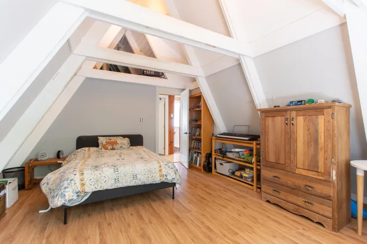 Bedroom with lofted ceilings and light wood finished floors