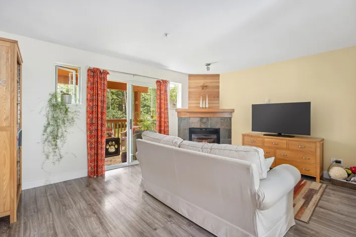 Living area with a fireplace and wood finished floors