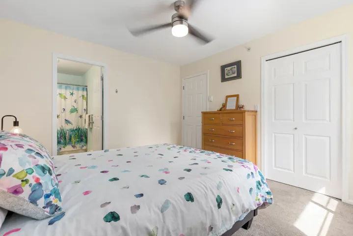 Bedroom with a closet, carpet floors, and ceiling fan