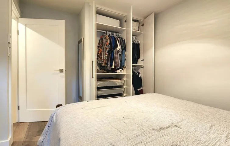 Bedroom featuring wood finished floors and a closet