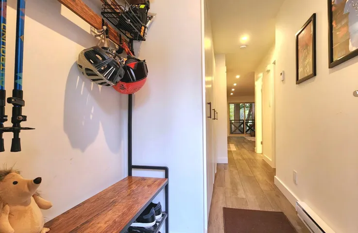 Hallway with baseboard heating, recessed lighting, and light wood finished floors