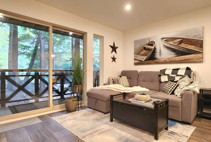 Living room with wood finished floors and a wealth of natural light
