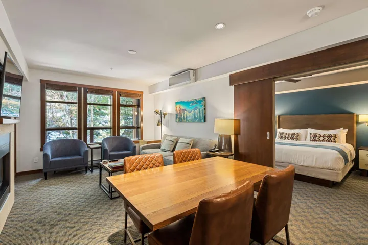 Carpeted dining room with a fireplace, baseboards, and ceiling fan