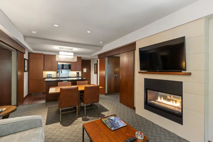 Living room featuring recessed lighting, dark carpet, and a fireplace