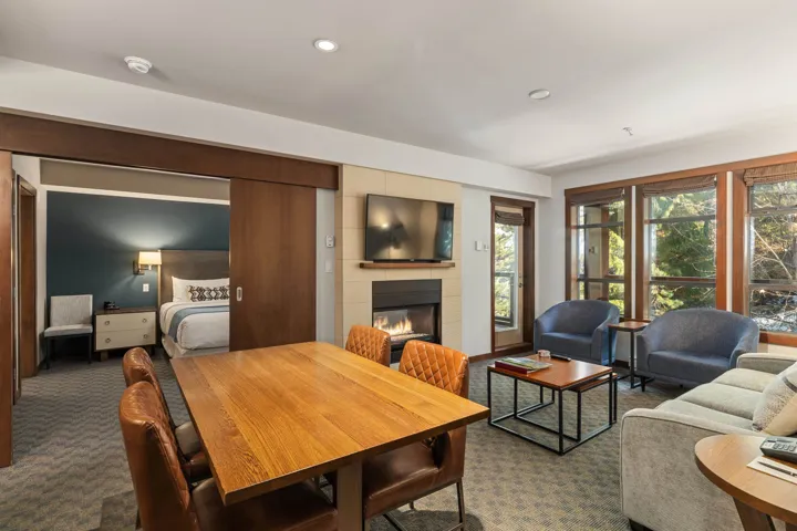 Dining space featuring recessed lighting, a large fireplace, and dark carpet