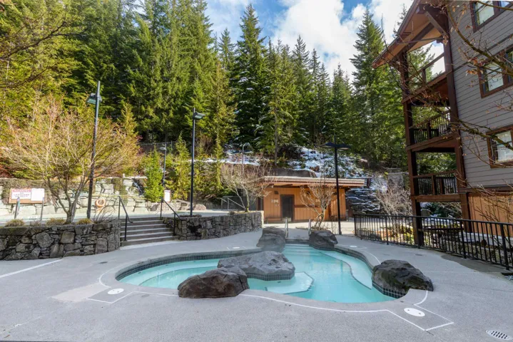 View of swimming pool with a jacuzzi