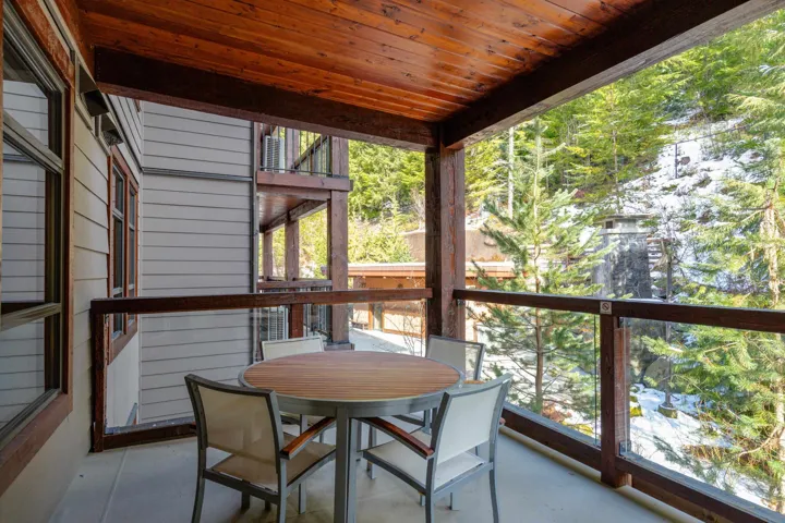 Sunroom with plenty of natural light and wood ceiling