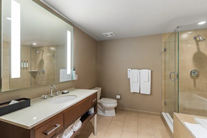 Bathroom with tile patterned flooring, a shower stall, baseboards, toilet, and vanity