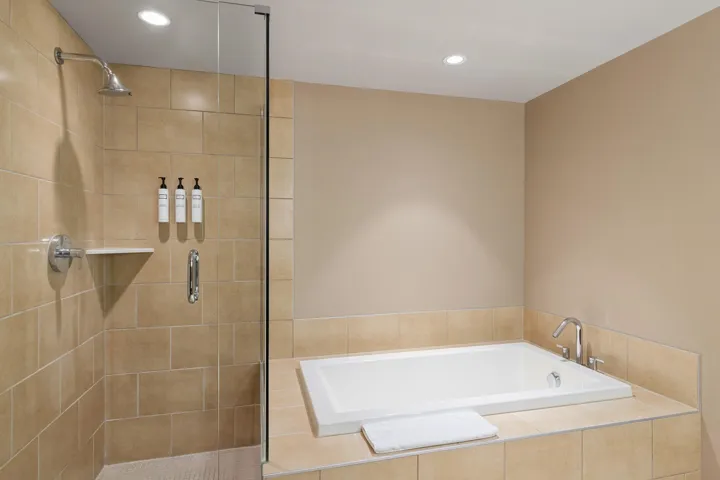 Full bathroom featuring a bath, recessed lighting, and a stall shower