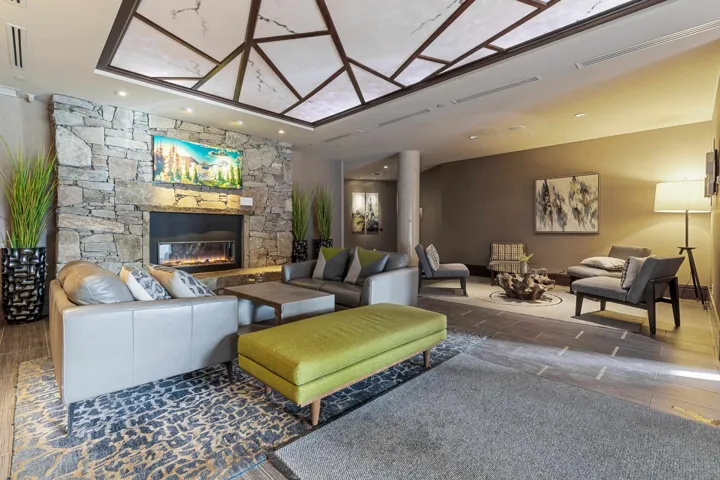 Living room featuring wood finished floors, recessed lighting, a fireplace, and visible vents