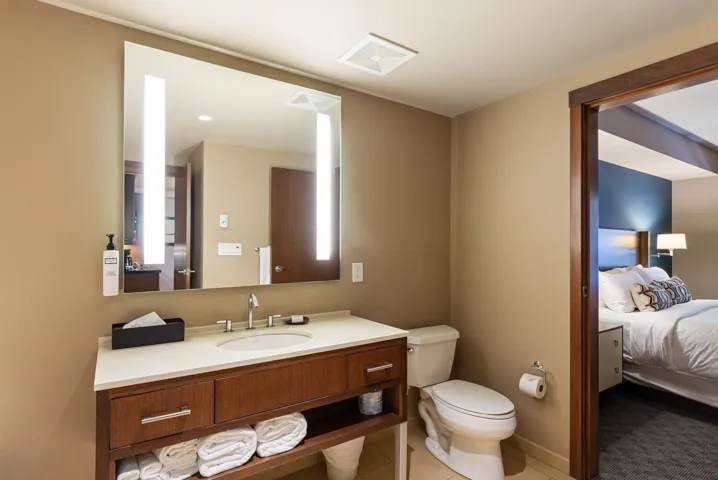 Bathroom featuring connected bathroom, toilet, and vanity