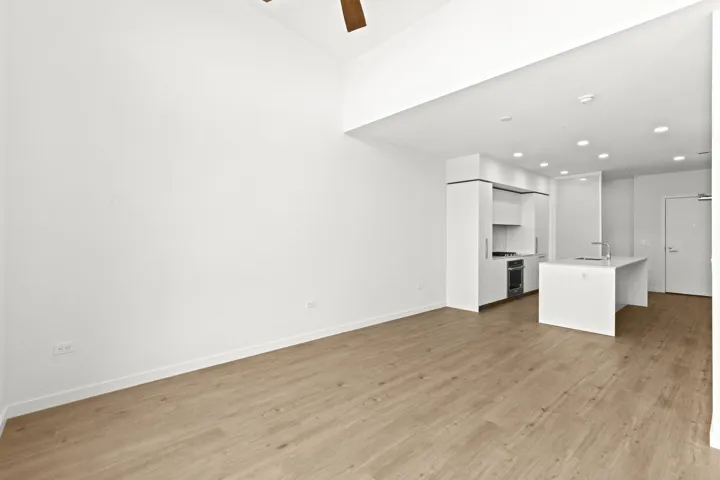 Unfurnished living room with light wood-style flooring, ceiling fan, and recessed lighting