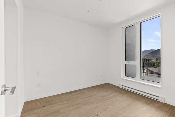 Spare room featuring a baseboard radiator, wood finished floors, and a mountain view