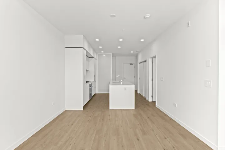 Unfurnished living room featuring light wood-type flooring and recessed lighting