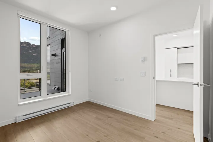 Empty room with a baseboard heating unit, light wood-style floors, and recessed lighting