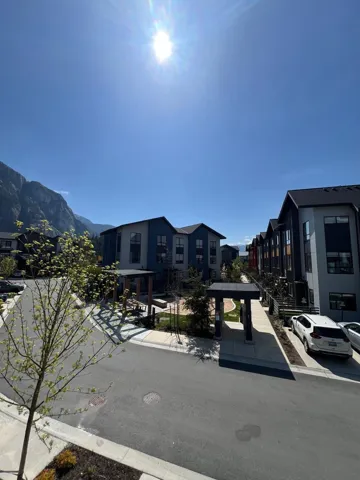 View of asphalt road with curbs and sidewalks