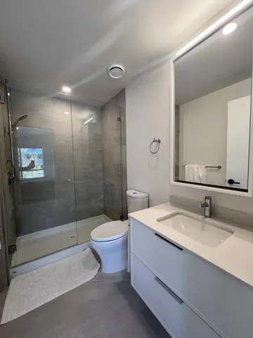 Full bath featuring vanity, a stall shower, and recessed lighting