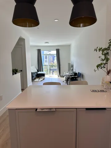 Kitchen with light wood-style flooring, gray cabinetry, light stone countertops, recessed lighting, and a peninsula