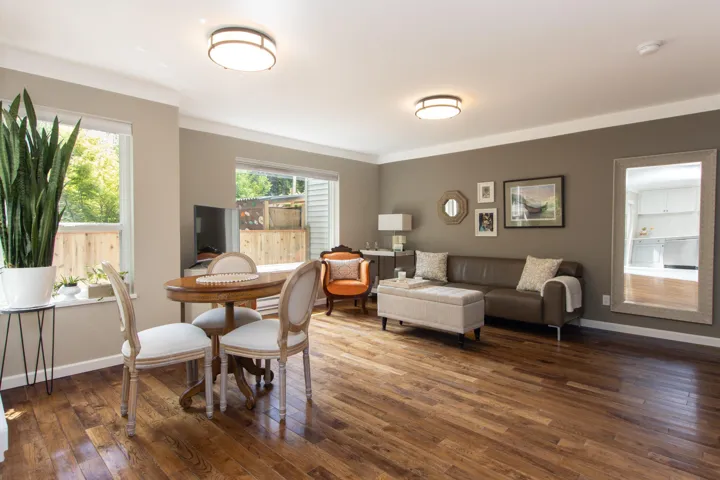 Living room featuring wood-type flooring, healthy amount of natural light, and baseboards