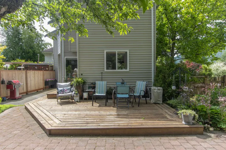 Rear view of property with a deck and an outdoor living space