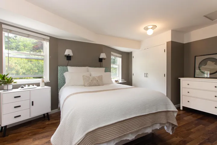 Bedroom with dark wood-style flooring and a closet
