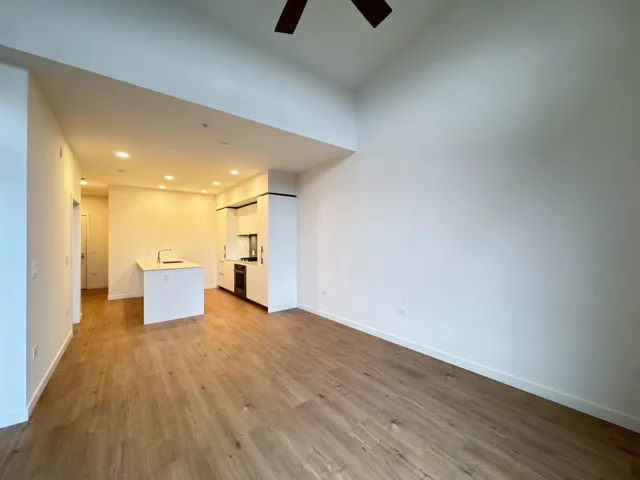 Unfurnished living room featuring light wood finished floors, ceiling fan, and recessed lighting